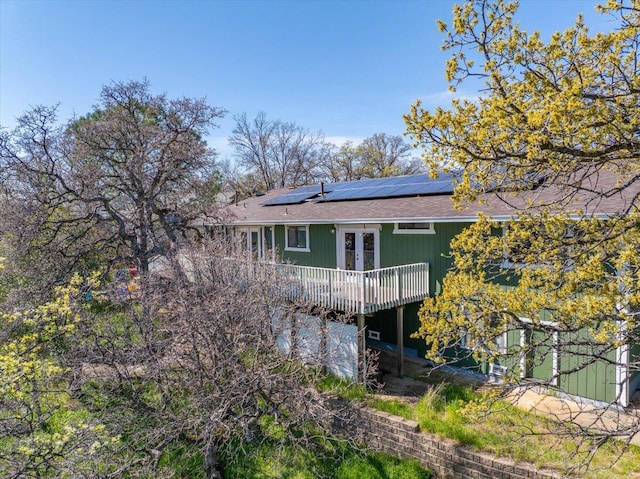 back of house with solar panels and french doors