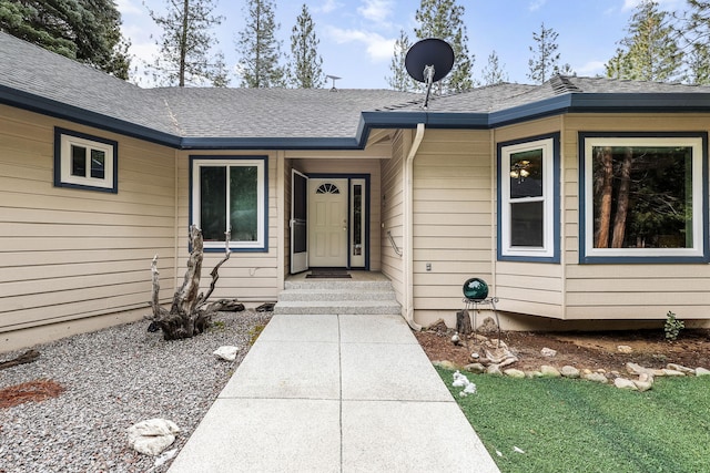 property entrance with roof with shingles