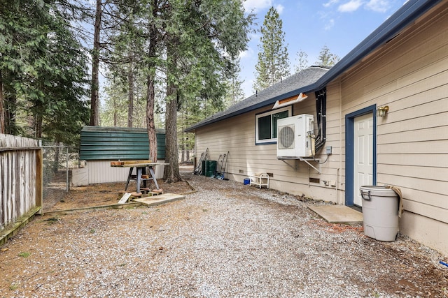 view of yard with ac unit and fence