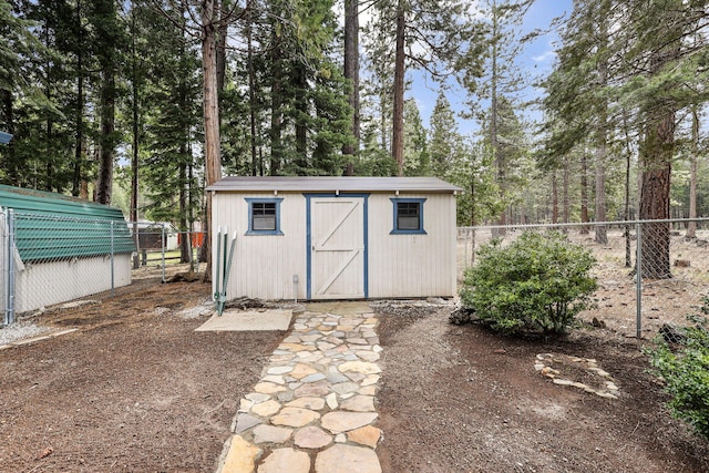 view of shed featuring fence
