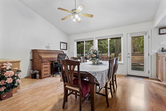 dining area with lofted ceiling, baseboards, light wood-type flooring, and a ceiling fan
