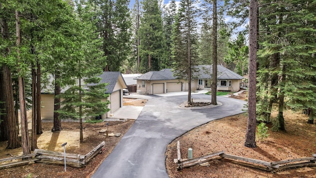 single story home with aphalt driveway and roof with shingles