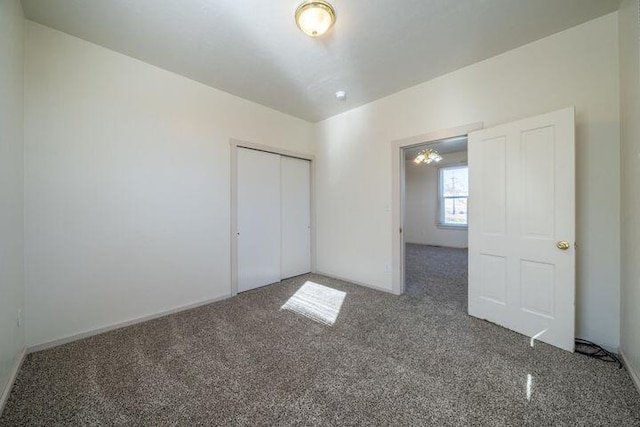 unfurnished bedroom with a closet and carpet
