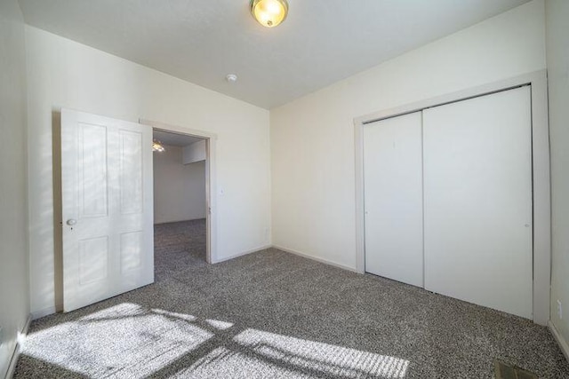 unfurnished bedroom with a closet and carpet