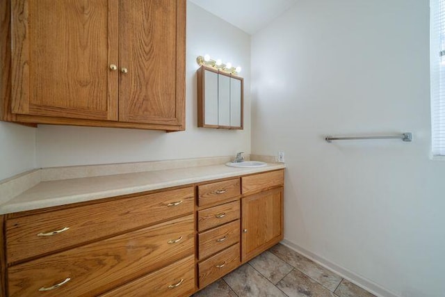 bathroom with vanity and baseboards