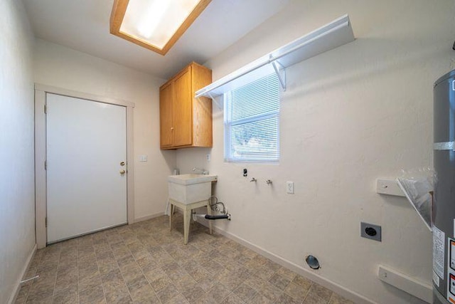 washroom featuring cabinet space, hookup for an electric dryer, and baseboards