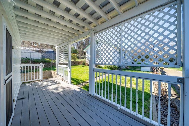 wooden terrace featuring a yard
