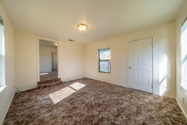 unfurnished bedroom featuring visible vents, baseboards, and carpet floors
