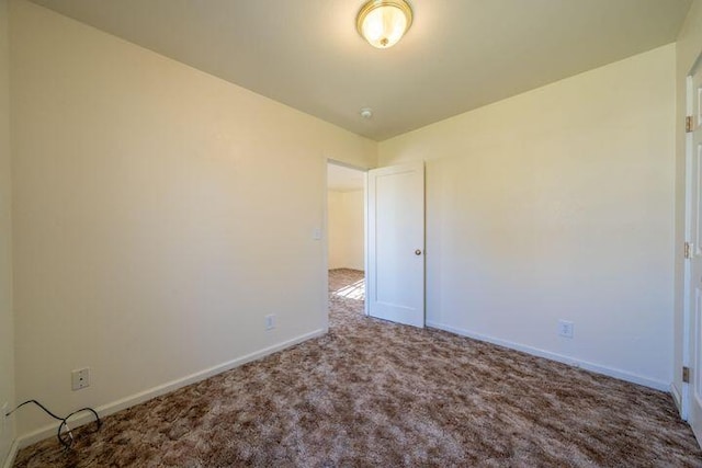 spare room with carpet flooring and baseboards