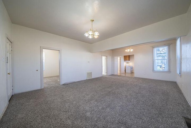 unfurnished living room with visible vents, a chandelier, carpet flooring, and vaulted ceiling