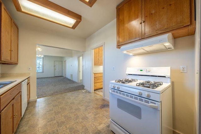 kitchen featuring brown cabinets, under cabinet range hood, white appliances, light countertops, and baseboards