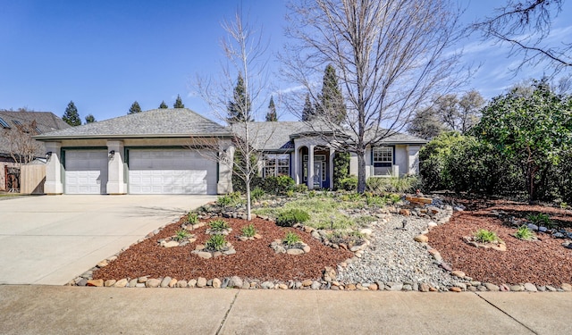 ranch-style home featuring concrete driveway, a garage, and stucco siding