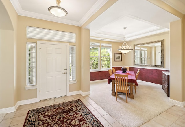 entrance foyer featuring baseboards, light tile patterned flooring, and crown molding