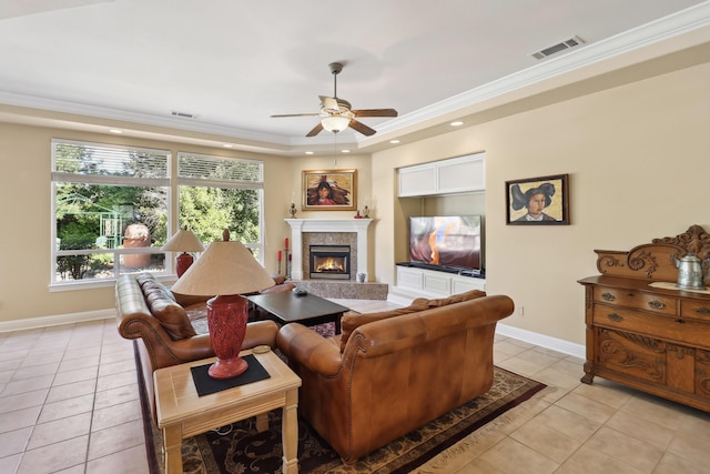 living area with visible vents, a warm lit fireplace, light tile patterned floors, baseboards, and ceiling fan