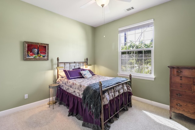 carpeted bedroom featuring visible vents, a ceiling fan, and baseboards