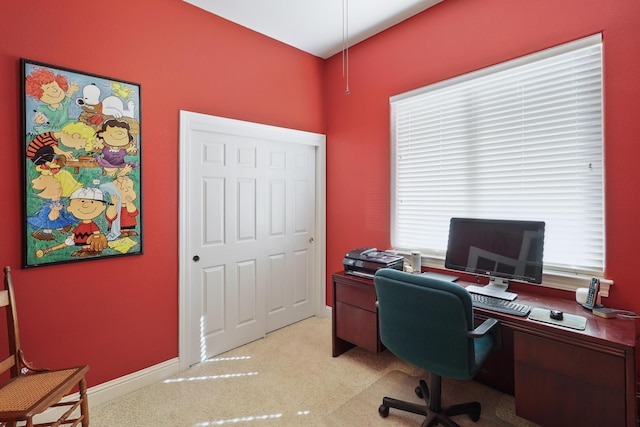 home office featuring baseboards and light carpet