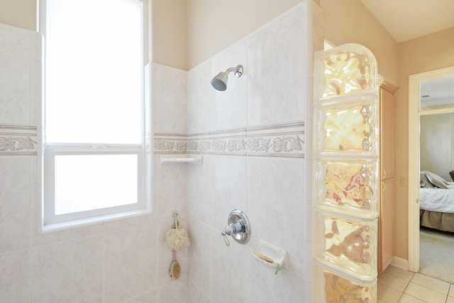 full bathroom featuring ensuite bath, tile patterned flooring, and a tile shower