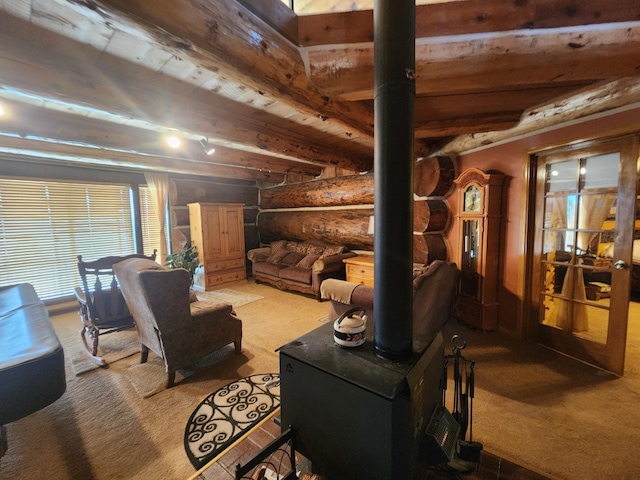 living area with beamed ceiling, light carpet, log walls, and a wood stove