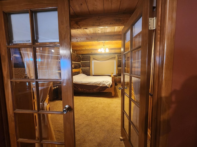 carpeted bedroom featuring rustic walls, beamed ceiling, and wood ceiling