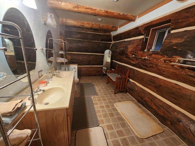 full bathroom featuring a sink, beam ceiling, and double vanity