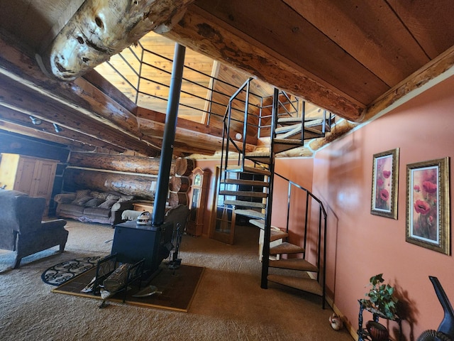 stairway featuring lofted ceiling with beams, a wood stove, carpet floors, and rustic walls