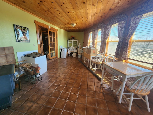 dining area featuring tile patterned floors, french doors, and wood ceiling