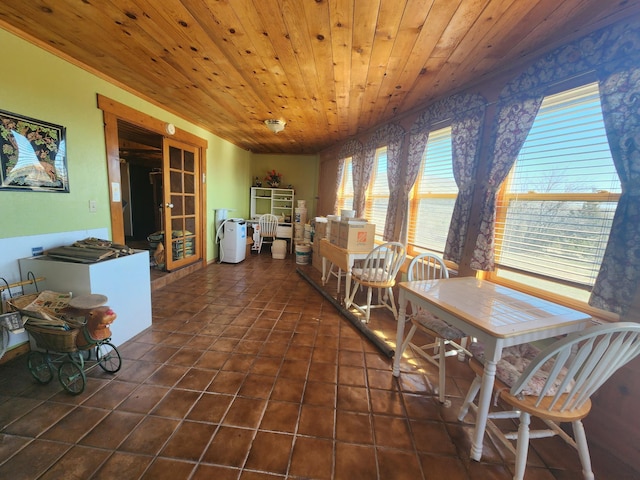 tiled dining area featuring french doors and wood ceiling