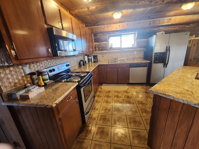 kitchen featuring beam ceiling, a sink, tasteful backsplash, appliances with stainless steel finishes, and wood ceiling