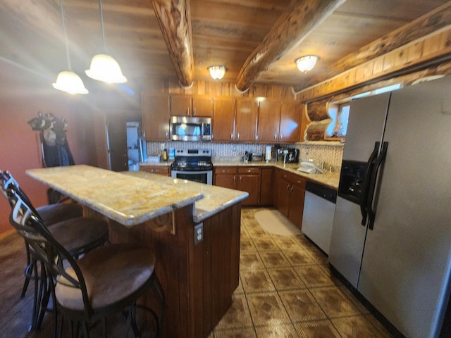 kitchen with backsplash, beamed ceiling, light countertops, brown cabinets, and stainless steel appliances