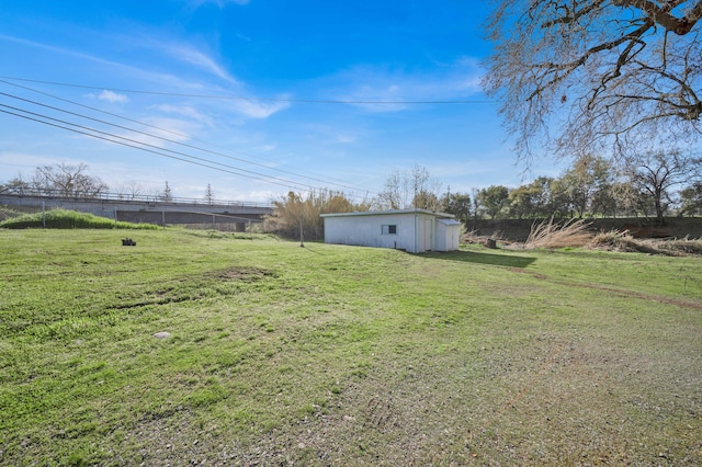 view of yard featuring an outbuilding, fence, and a pole building