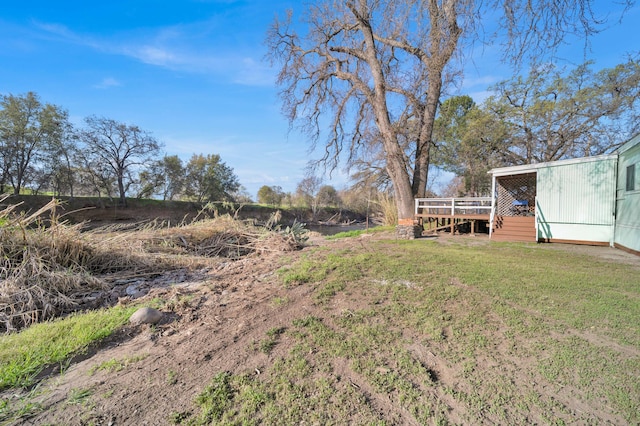 view of yard with a wooden deck