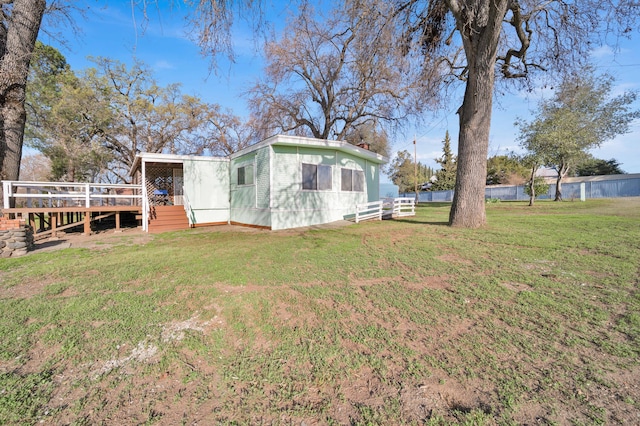 view of yard with a deck and fence