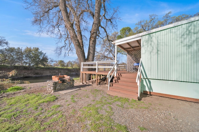 view of yard featuring a deck and stairs