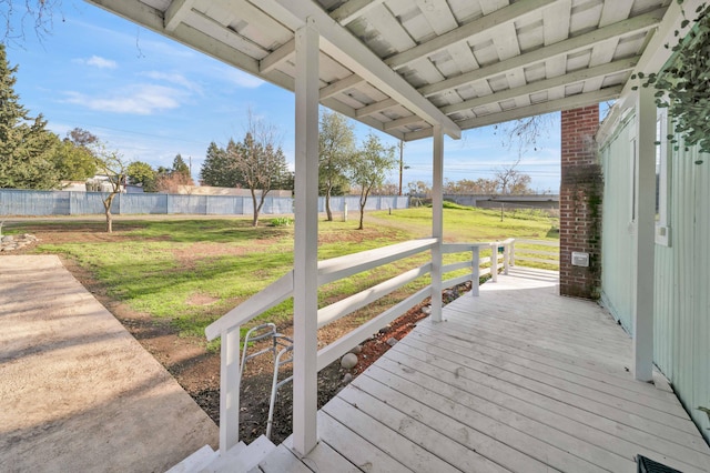 wooden deck with a lawn and fence