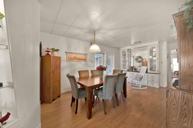 dining area with light wood-style flooring