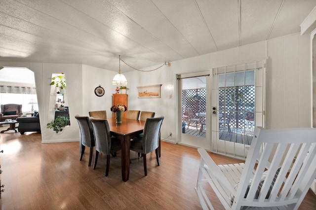 dining room featuring french doors, a textured ceiling, and wood finished floors