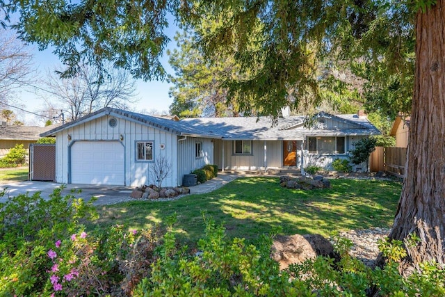 ranch-style house with an attached garage, a front lawn, and fence