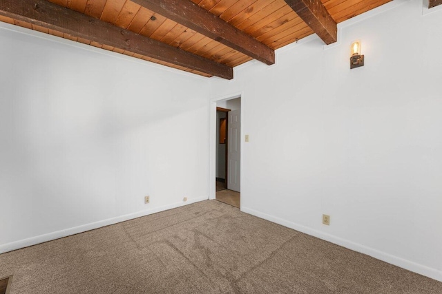 carpeted spare room featuring beamed ceiling, wood ceiling, and baseboards