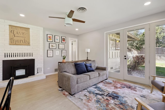 living area with visible vents, wood finished floors, recessed lighting, french doors, and ceiling fan