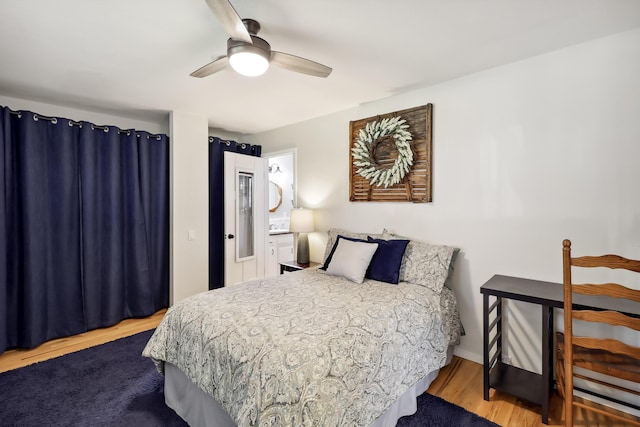 bedroom featuring ceiling fan, baseboards, and wood finished floors