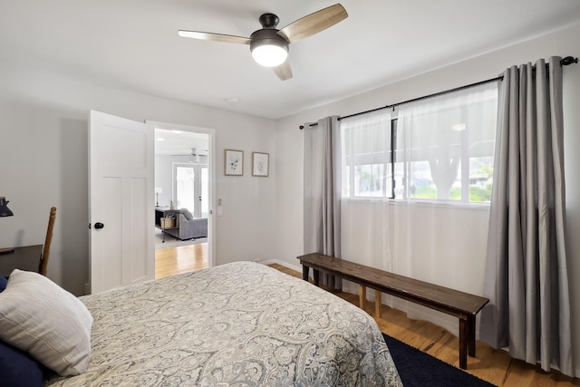 bedroom featuring light wood-style flooring, multiple windows, and a ceiling fan