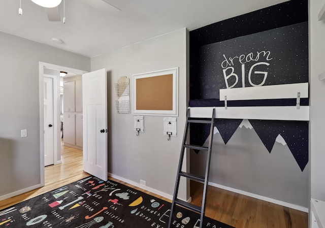 bedroom featuring wood finished floors and baseboards