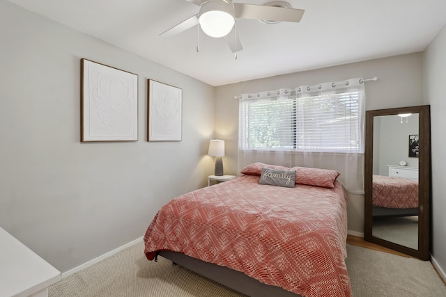 carpeted bedroom with baseboards and ceiling fan