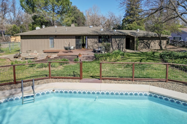 view of pool with a lawn, fence, a deck, and a fenced in pool