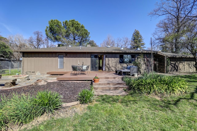 back of property featuring a wooden deck, board and batten siding, and fence