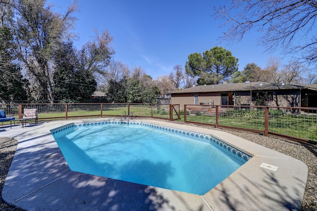 view of swimming pool with a patio area, fence, and a fenced in pool