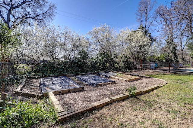 view of yard featuring a vegetable garden and fence