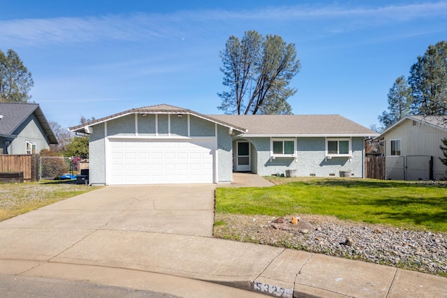 ranch-style home with a front lawn, concrete driveway, an attached garage, and fence