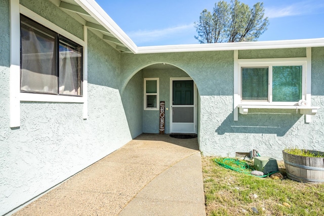 doorway to property with stucco siding