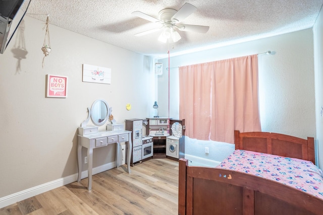 bedroom featuring baseboards, a textured ceiling, ceiling fan, and light wood finished floors